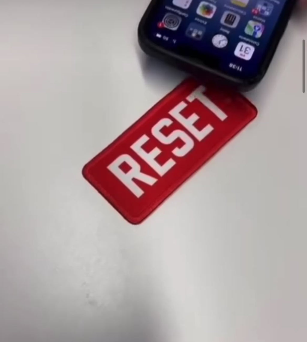 Tapping the RESET Founding Patch with a 
smartphone — one tap opens your identity to the world.